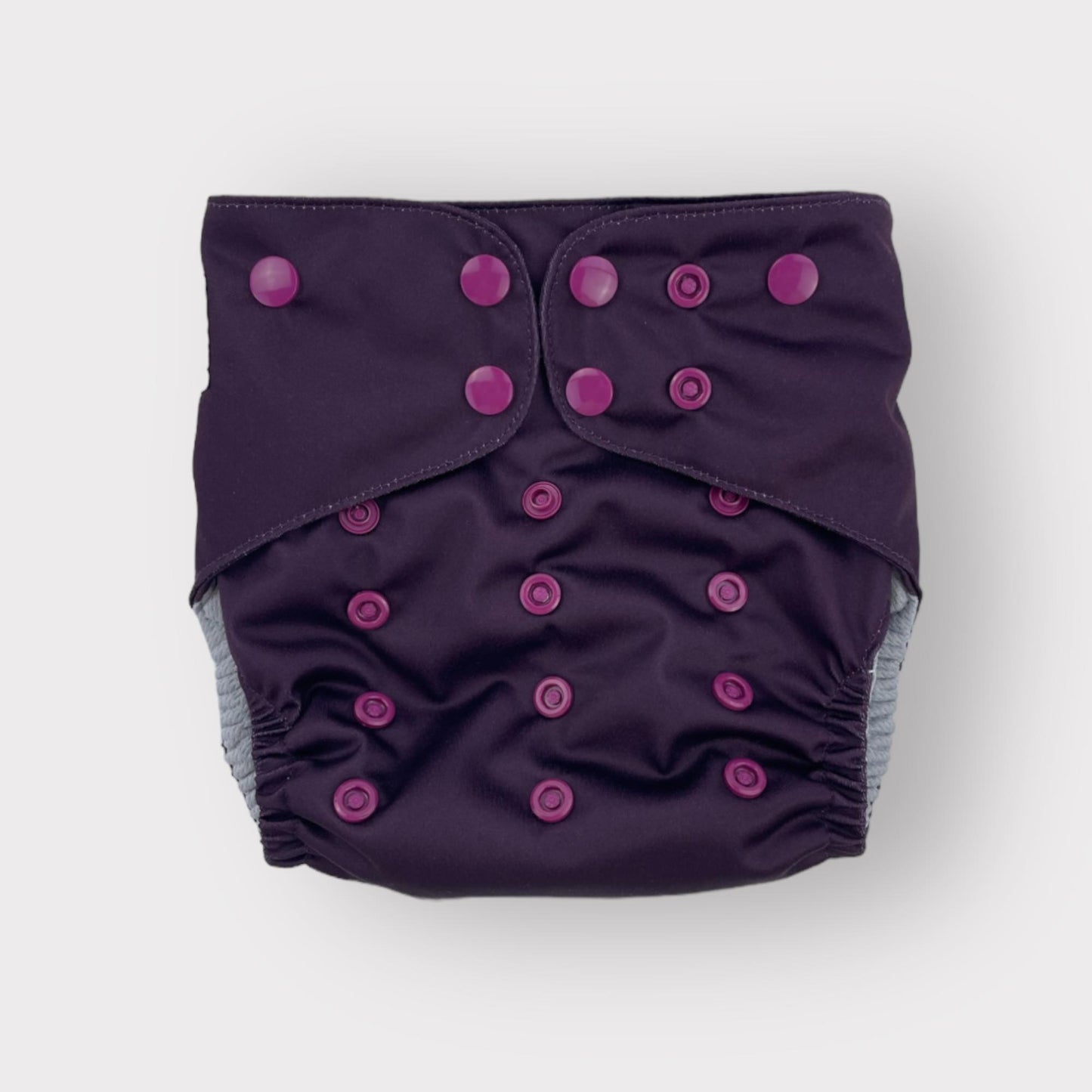 A deep wine/burgungy colored pocket style reusable diaper from Wickham Wild.