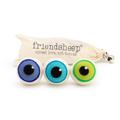 Three colorful eye-shaped wool dryer balls with a 'friendsheep' drawstring bag on a white background.